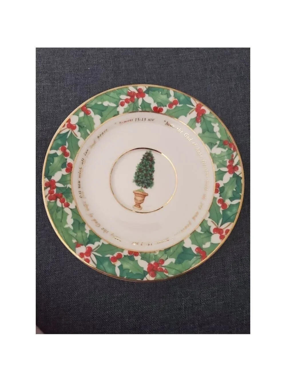 vintage teacup and saucer set features a festive holly pattern.